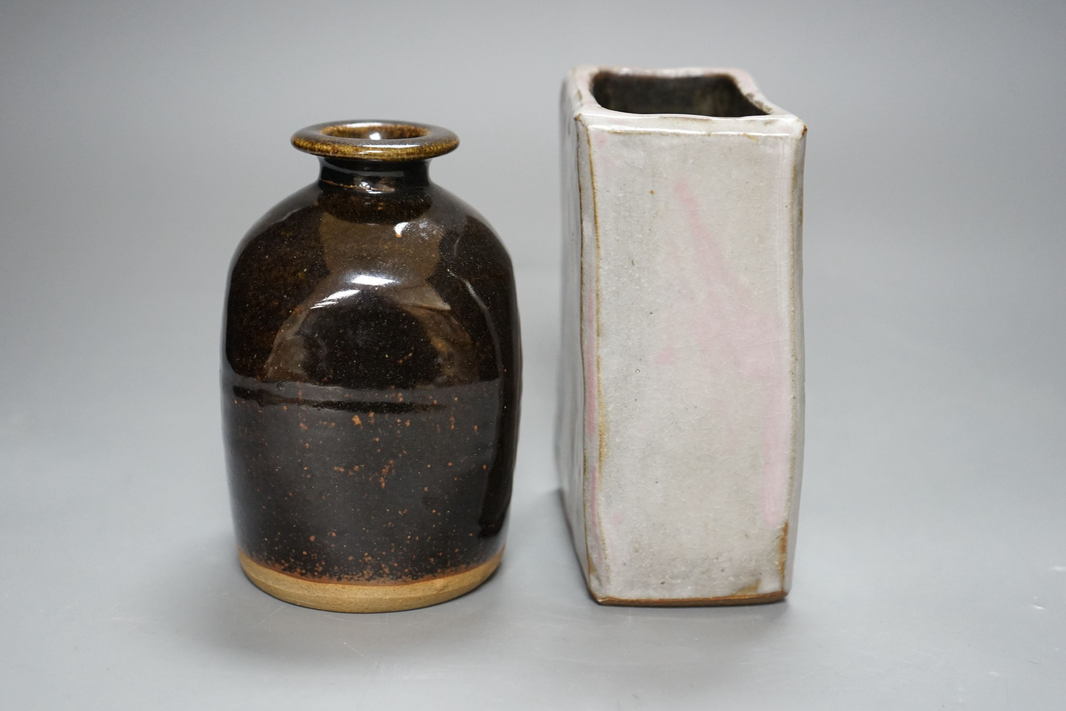 British Studio Pottery; a tenmoku glazed bottle vase, with impressed mark, together with an abstract rectangular blue glaze vase with brown and pink undertones, unmarked, 15cm tall, (2)